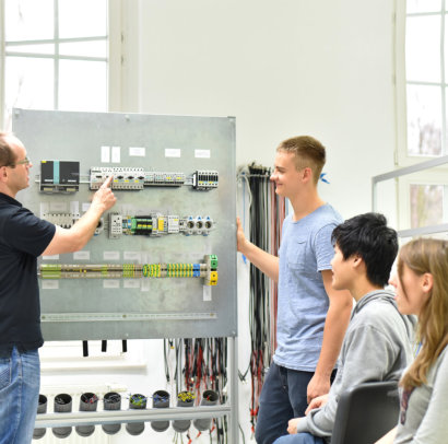 teacher teaching his student about electronic wires