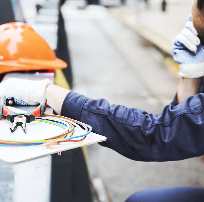 man fixing some electronic wire