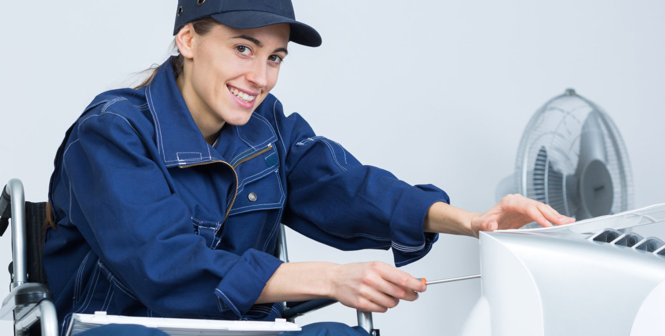 woman sitting in the wheelchair fixing appliances