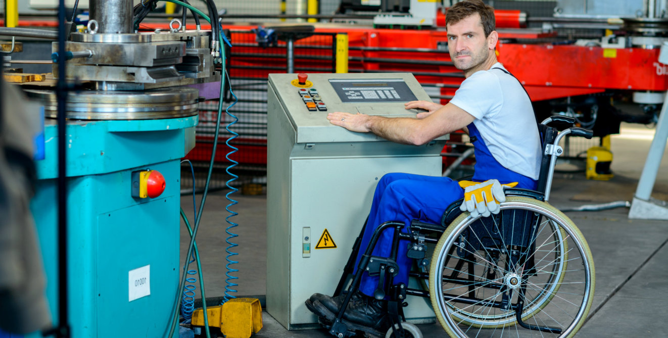 man sitting in the wheelchair operating machine