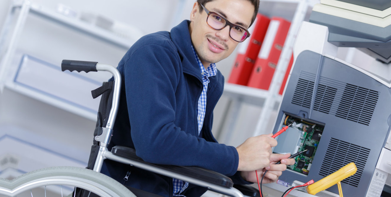 man sitting in the wheelchair fixing the scanner